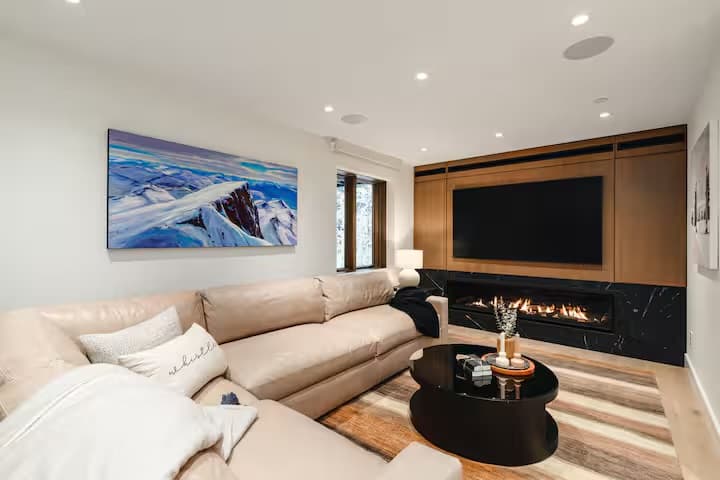 Media room with sectional sofa and gas fireplace